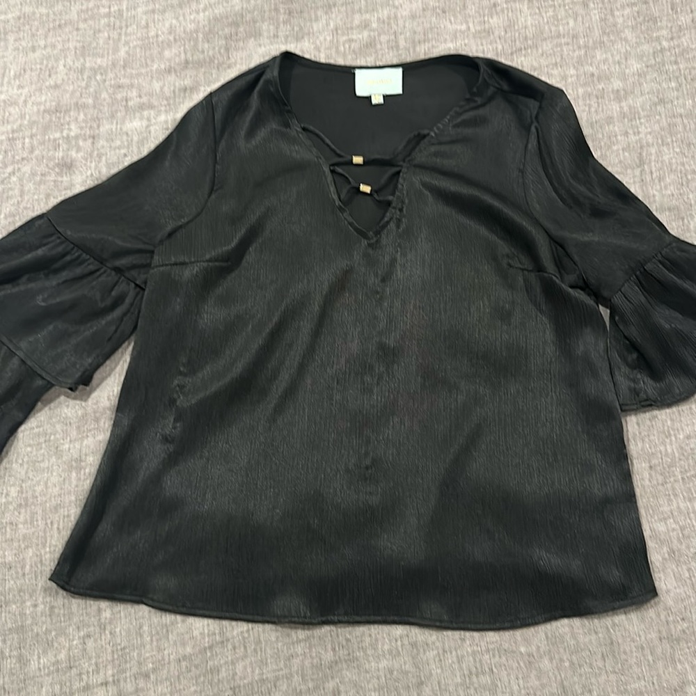 Cute black shirt, long sleeve with ruffles and gold accents in front